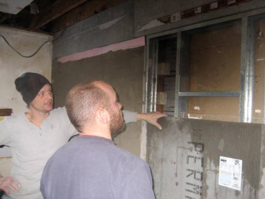 Adam Gauvin and Jeremy Brown, lead mason, consult